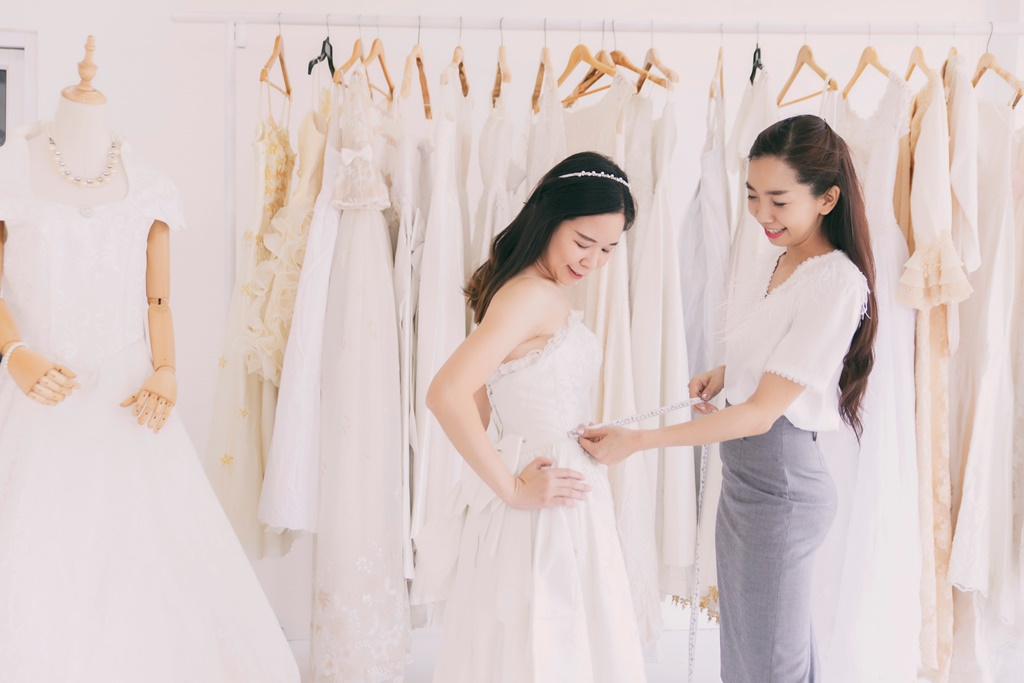 Woman trying out a wedding gown after taking a wedding loan in Singapore